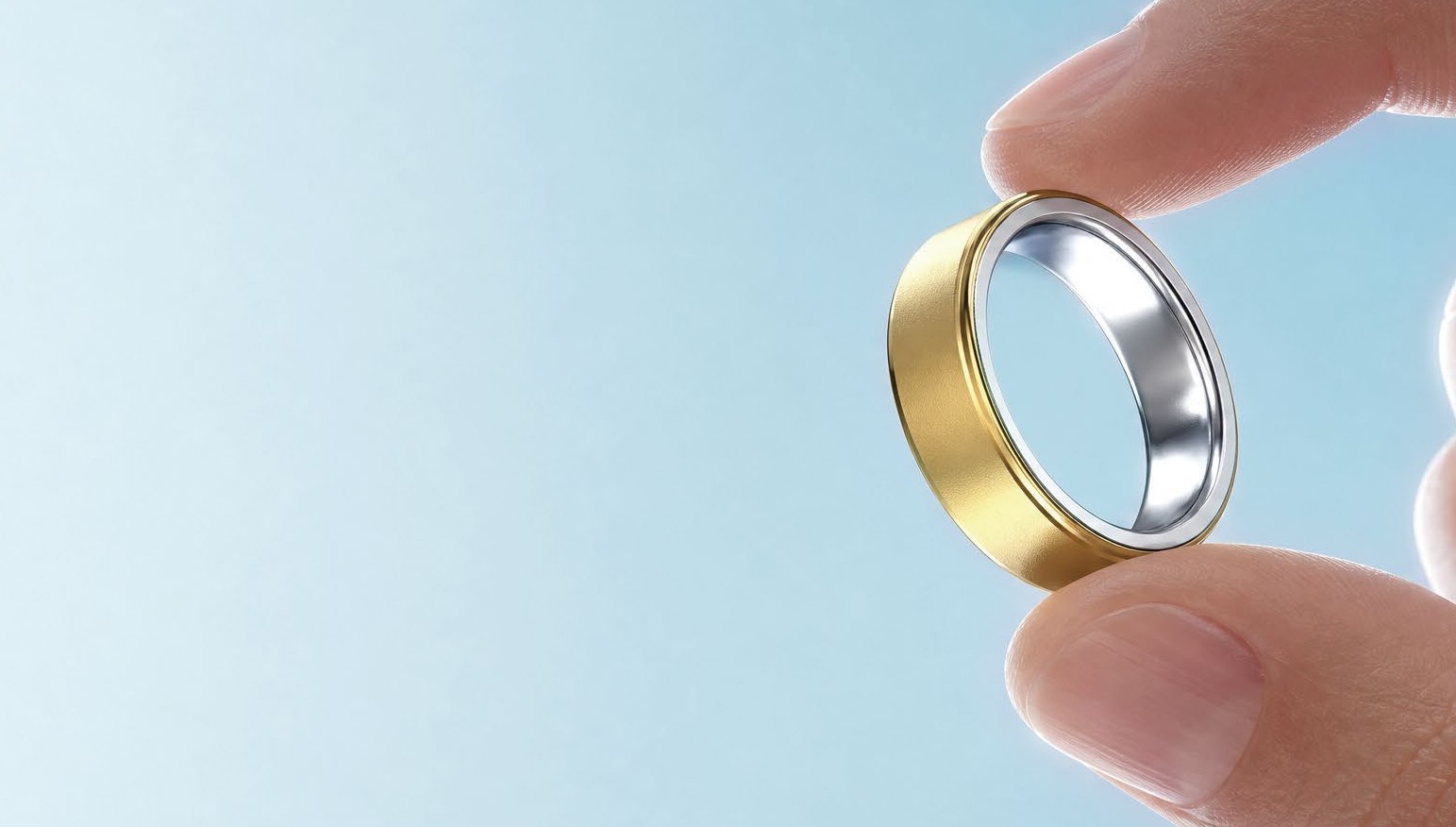 Fingers holding the 4 g smart ring